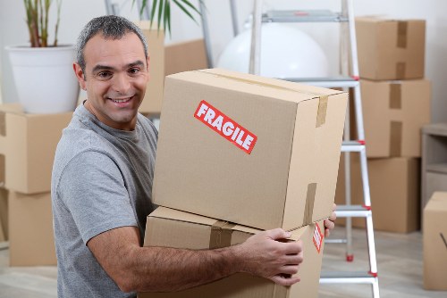 Local moving truck loading furniture near Colliers Wood properties