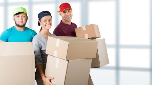 Packed moving boxes and furniture ready for transport by removals van